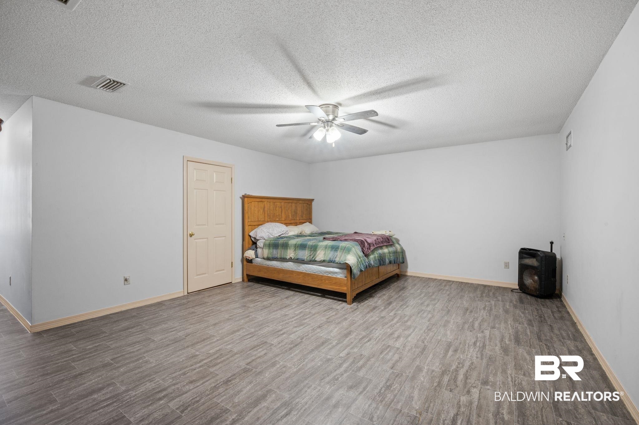 100 Orleans Way Daphne, AL 36526 - Photo 18 of 31 Unfurnished bedroom featuring hardwood / wood-style floors, a textured ceiling, and ceiling fan