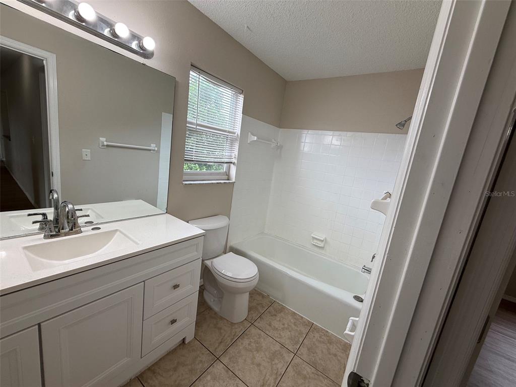 855 Jamaica Road Venice, FL 34293 - Photo 16 of 19 a bathroom with a double vanity sink toilet and shower