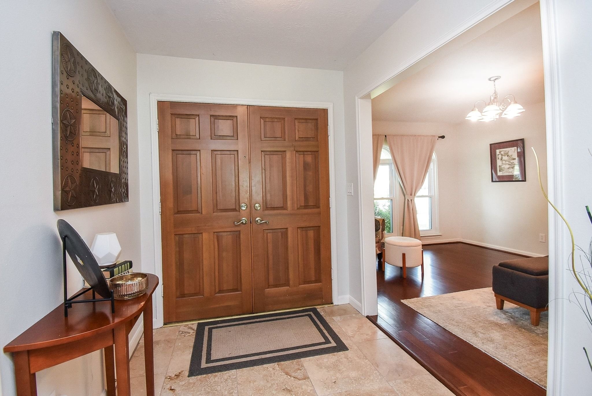 2930 Kevin Lane Houston, TX 77080 - Photo 16 of 50 This welcoming entryway features double wooden doors, and a tiled floor. It opens into a bright living area with hardwood floors and elegant lighting.