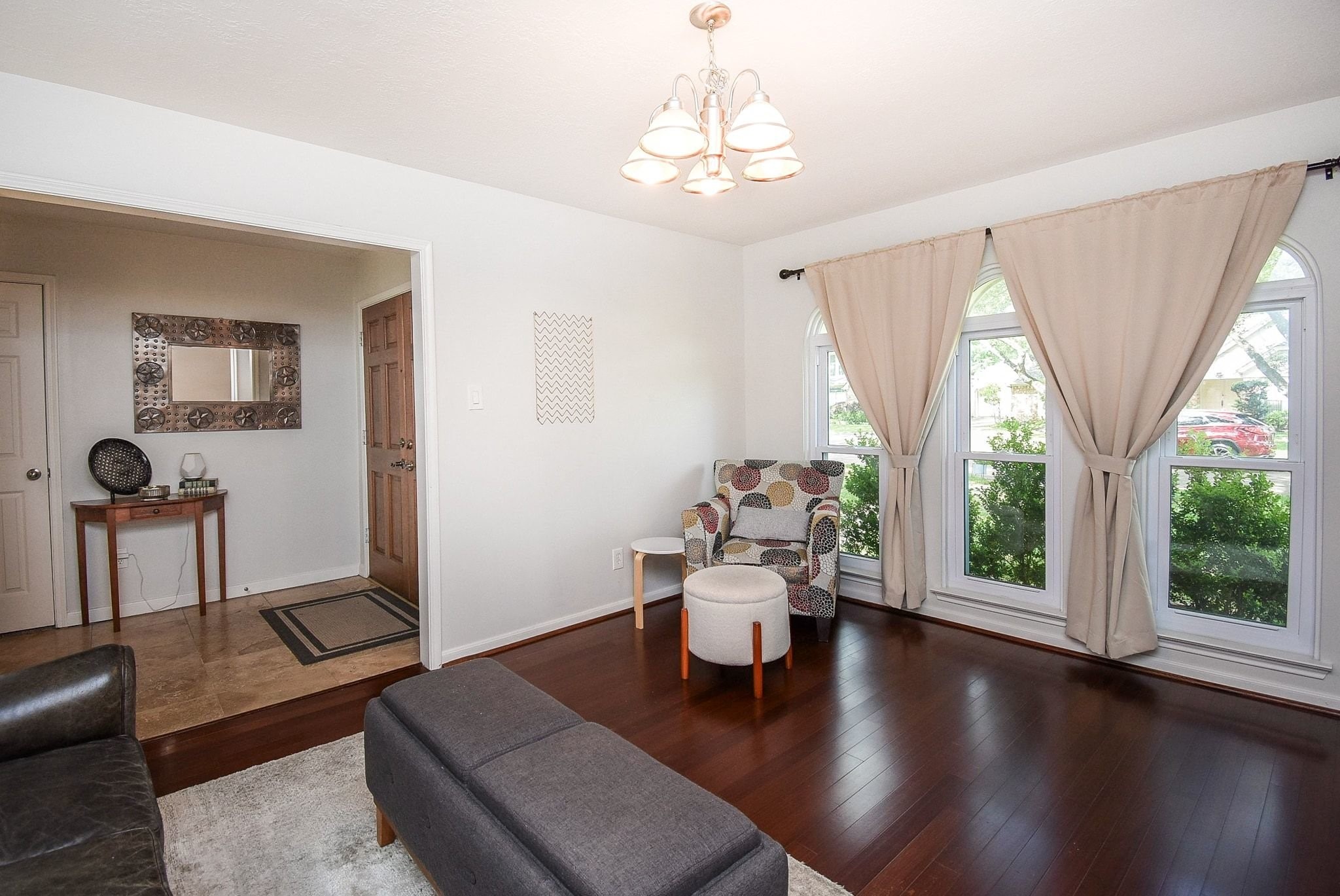 2930 Kevin Lane Houston, TX 77080 - Photo 20 of 50 Bright living area with hardwood floors, large windows, and cozy seating. Neutral tones and stylish lighting create a welcoming atmosphere.