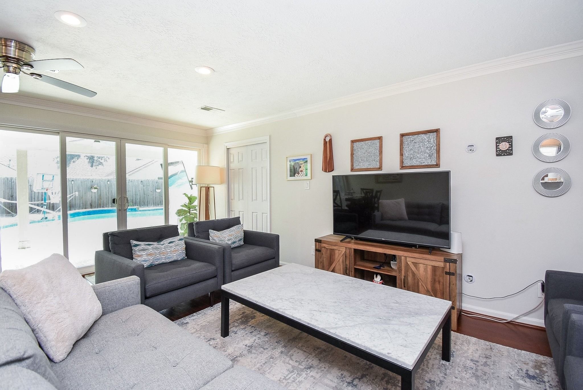 2930 Kevin Lane Houston, TX 77080 - Photo 24 of 50 This inviting living room features a cozy seating area. It has sliding glass doors leading to a backyard with a swimming pool, allowing for natural light and a view of the outdoors. Bringing the outdoors in.