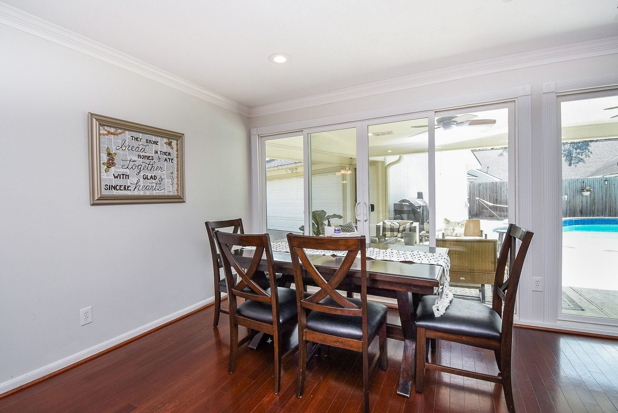 2930 Kevin Lane Houston, TX 77080 - Photo 27 of 50 This dining area features elegant wood flooring. It opens up to a patio with large sliding glass doors, providing a view of the outdoor pool, perfect for entertaining and relaxing.