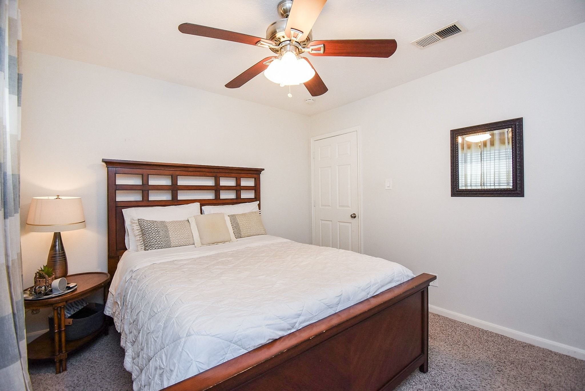 2930 Kevin Lane Houston, TX 77080 - Photo 42 of 50 This cozy bedroom features a comfortable bed with a wooden headboard, a ceiling fan, and soft carpeting. It has a warm and inviting atmosphere.