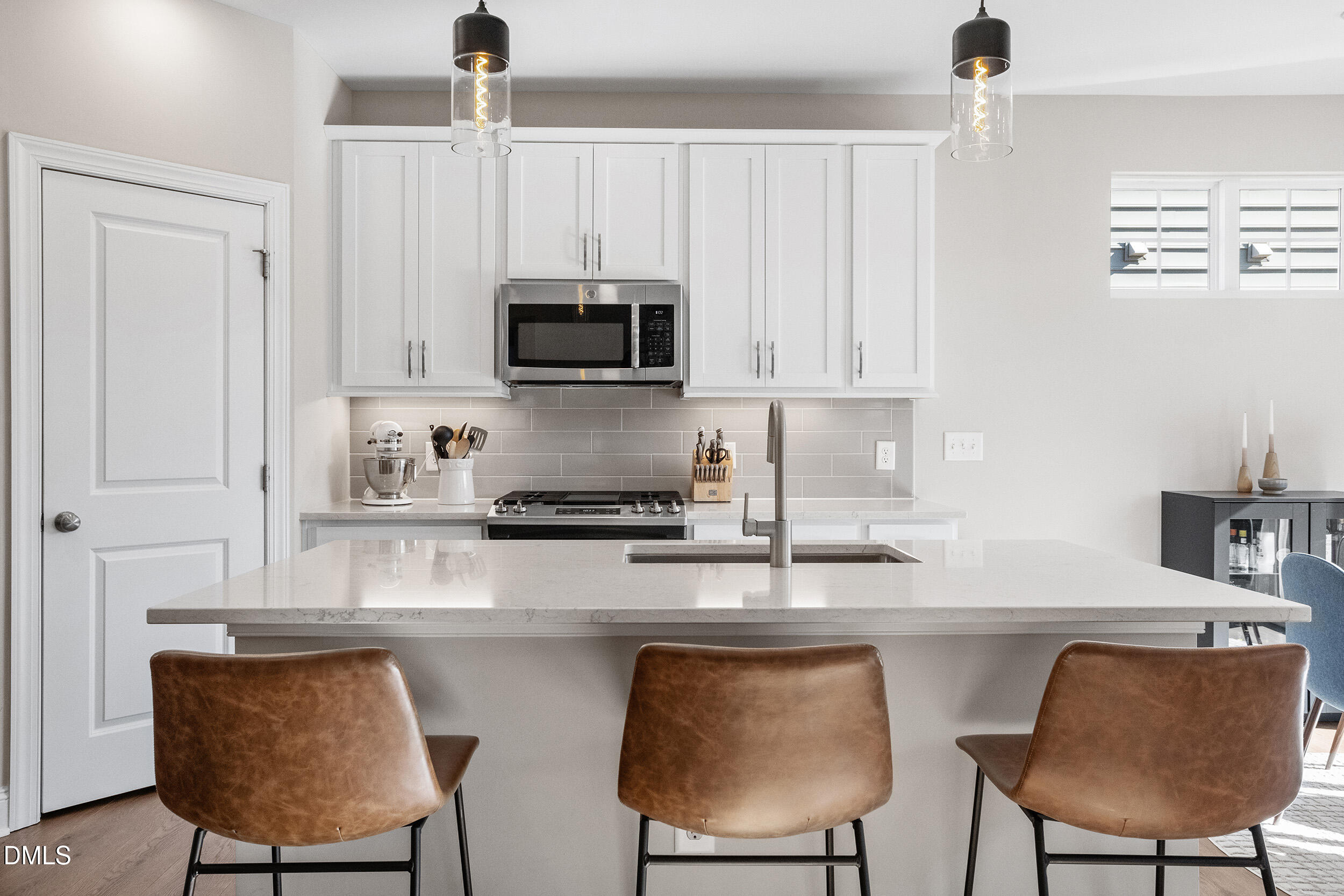 1602 Farm Pond Trail Durham, NC 27703 - Photo 11 of 43 a kitchen with stainless steel appliances a stove a sink a microwave a refrigerator and cabinets