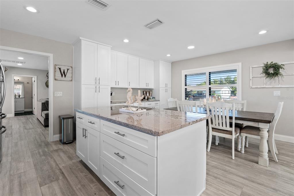 3422 West Shell Point Road Ruskin, FL 33570 - Photo 10 of 54 a kitchen with stainless steel appliances granite countertop a table chairs and a refrigerator