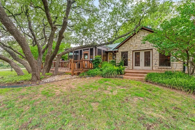 a front view of a house with yard and green space