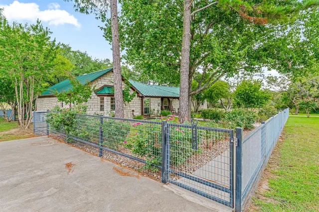 a view of a house with backyard and balcony