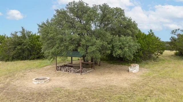 a backyard of a house with table and chairs