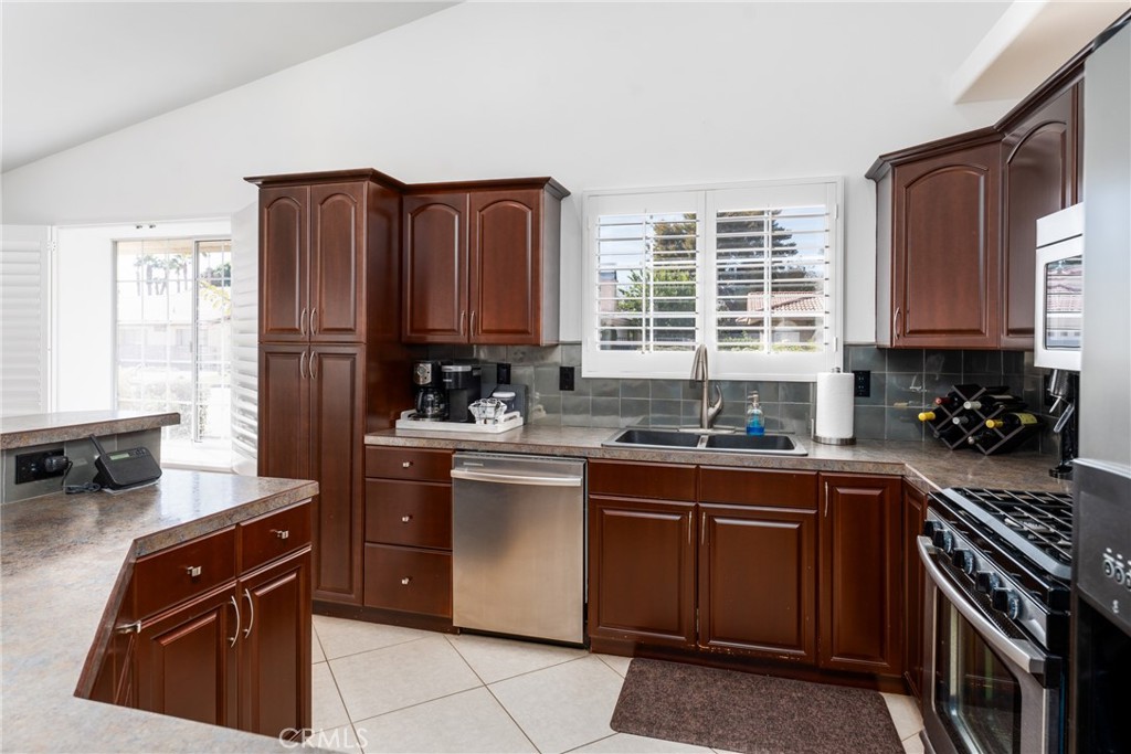 48330 Mamie Way Indio, CA 92201 - Photo 19 of 46 a kitchen with stainless steel appliances granite countertop a stove a sink dishwasher and a refrigerator