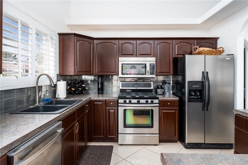 48330 Mamie Way Indio, CA 92201 - Photo 20 of 46 a kitchen with a refrigerator stove and sink