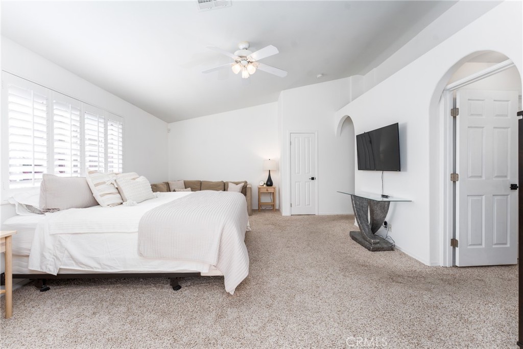 48330 Mamie Way Indio, CA 92201 - Photo 25 of 46 a spacious bedroom with a bed and a flat screen tv