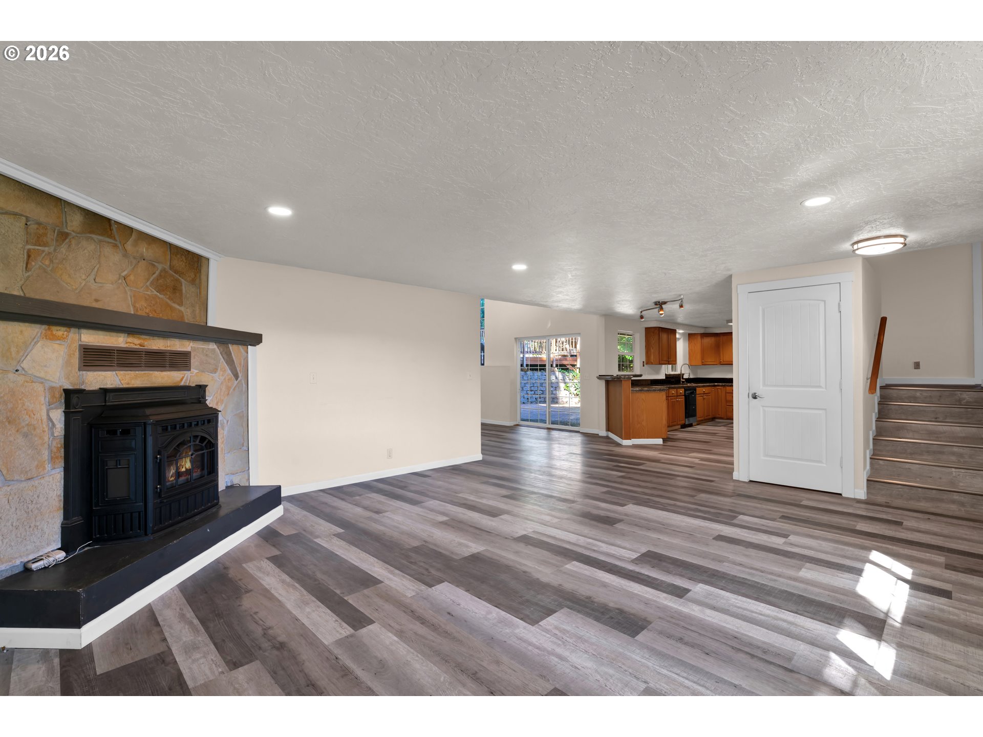 947 South R Street Cottage Grove, OR 97424 - Photo 11 of 48 a view of empty room with wooden floor and fireplace
