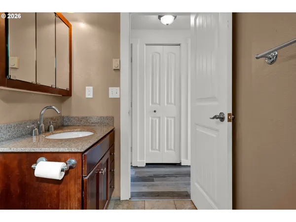 a bathroom with a granite countertop sink and a mirror