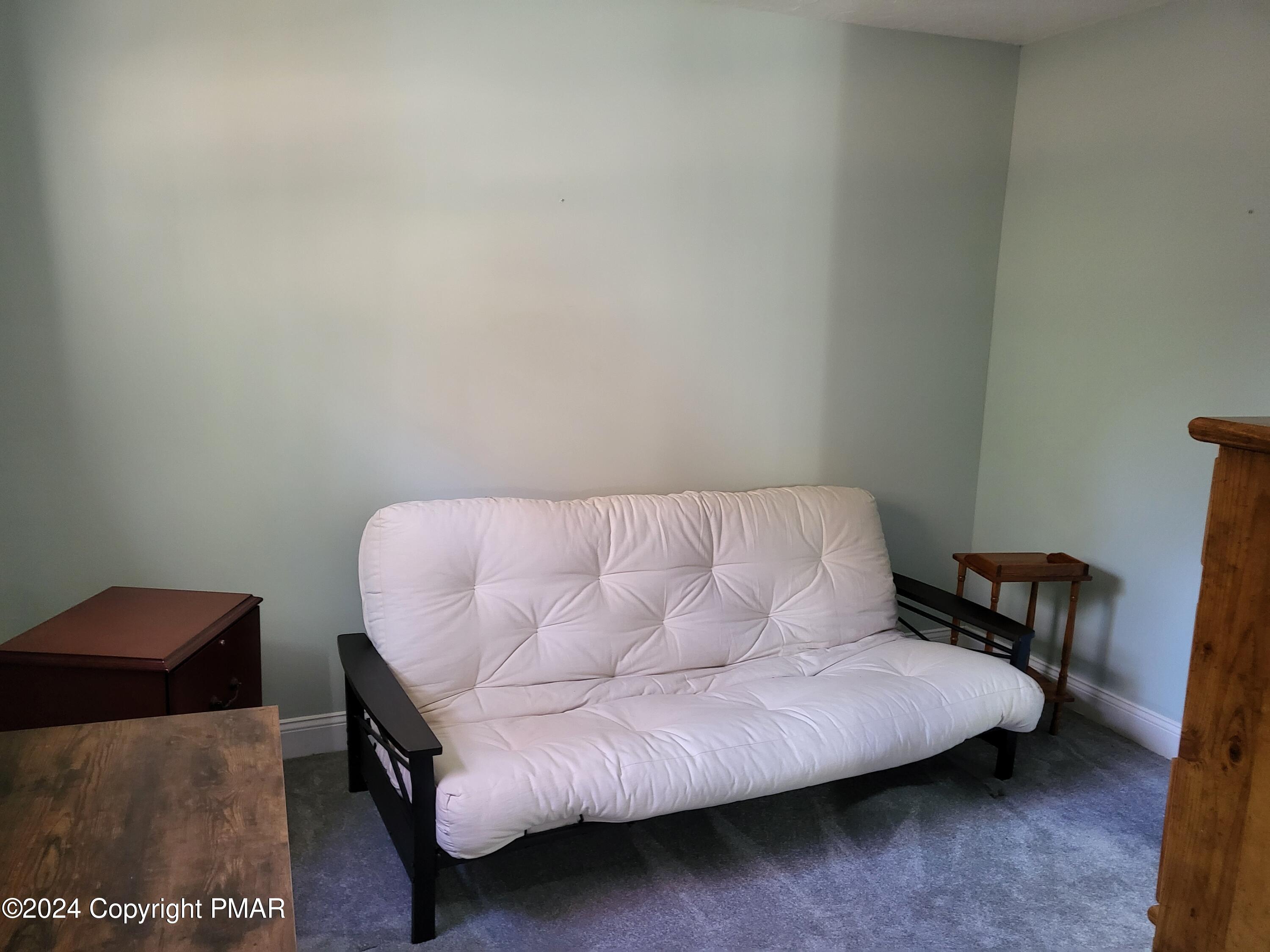 191 Sportsmen Drive Cresco, PA 18326 - Photo 18 of 29 a bedroom with a bed and a chair