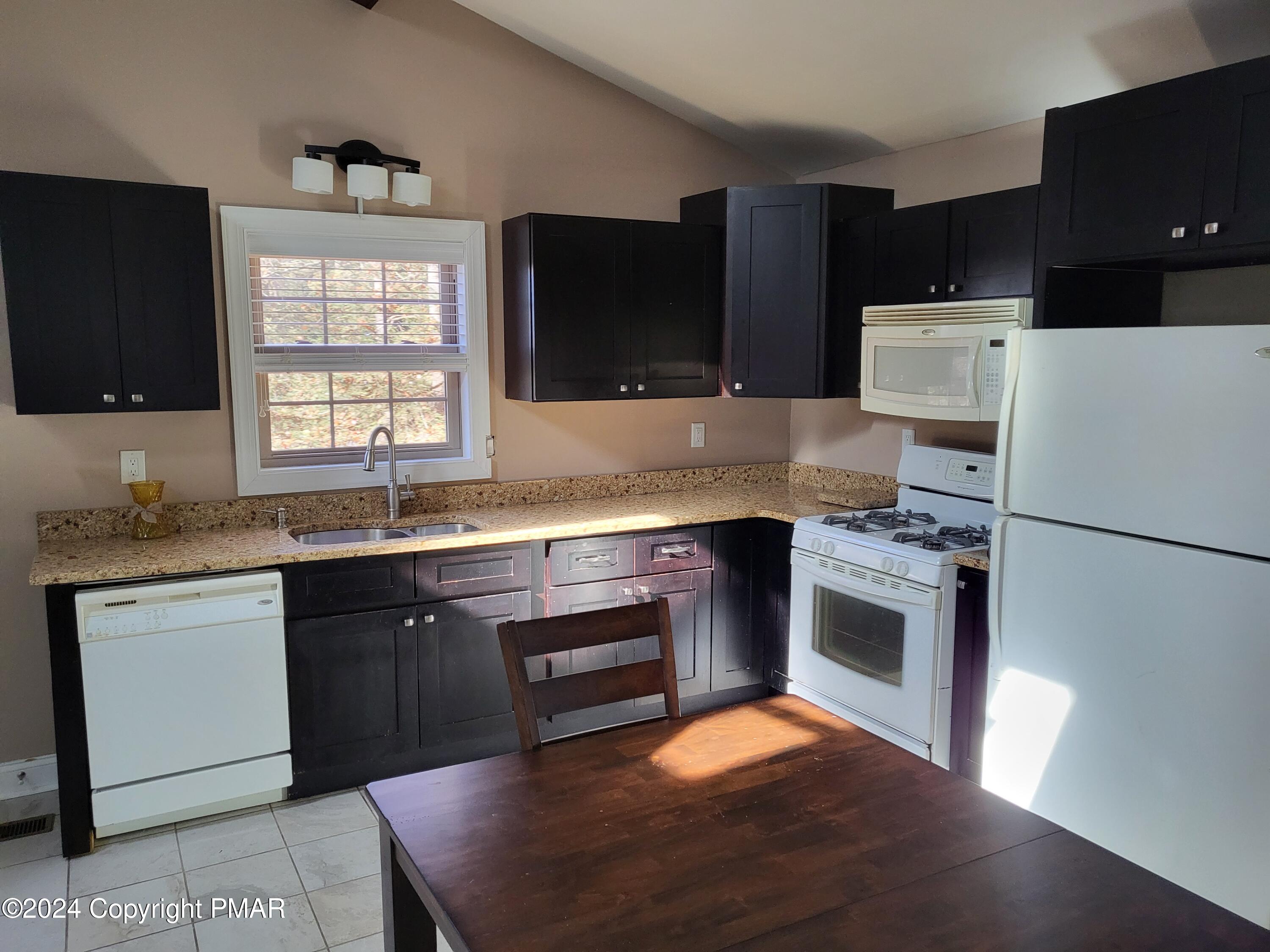 191 Sportsmen Drive Cresco, PA 18326 - Photo 6 of 29 a kitchen with granite countertop appliances a sink and a stove