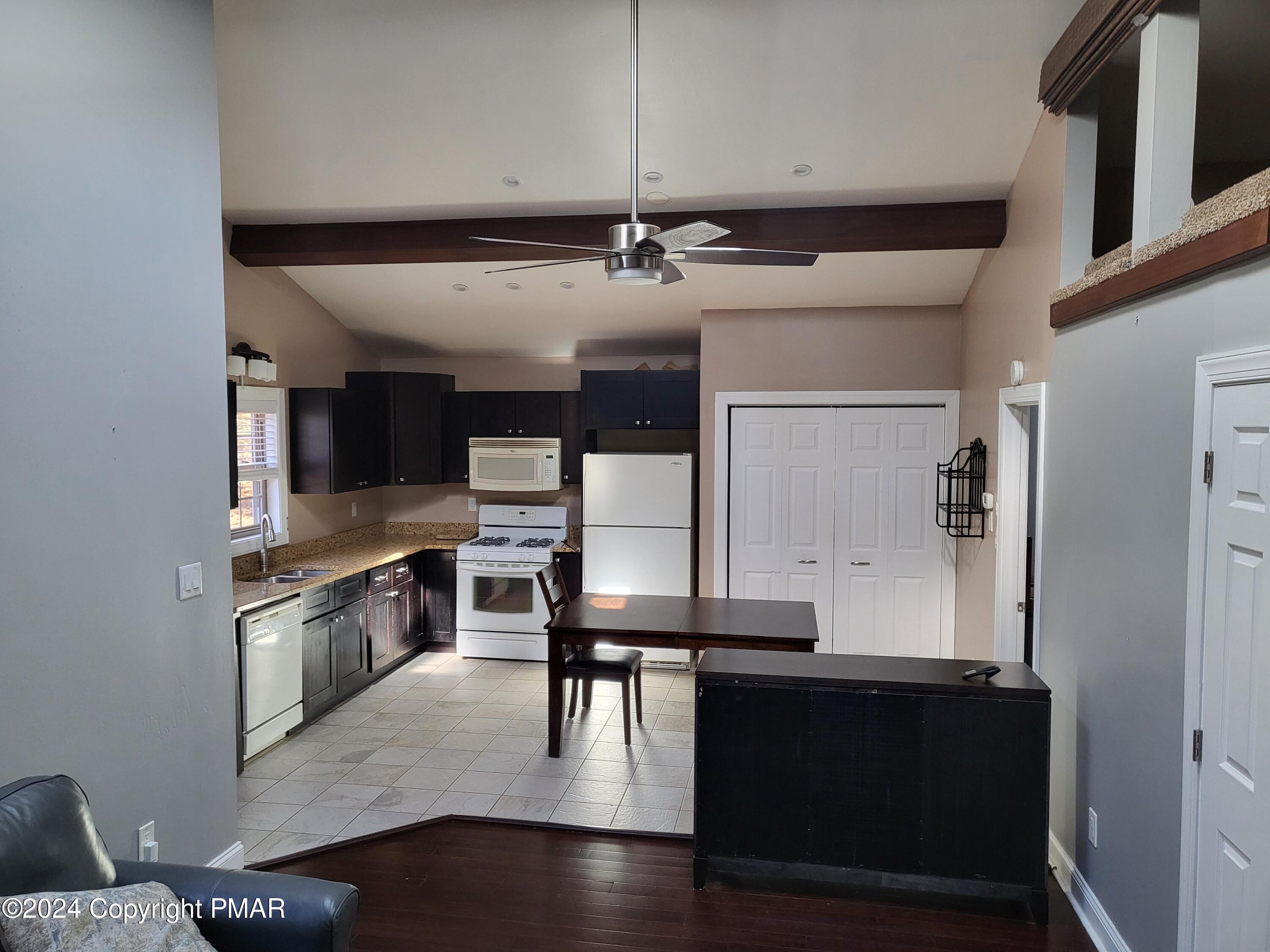 191 Sportsmen Drive Cresco, PA 18326 - Photo 7 of 29 a kitchen with granite countertop a stove a sink and a refrigerator