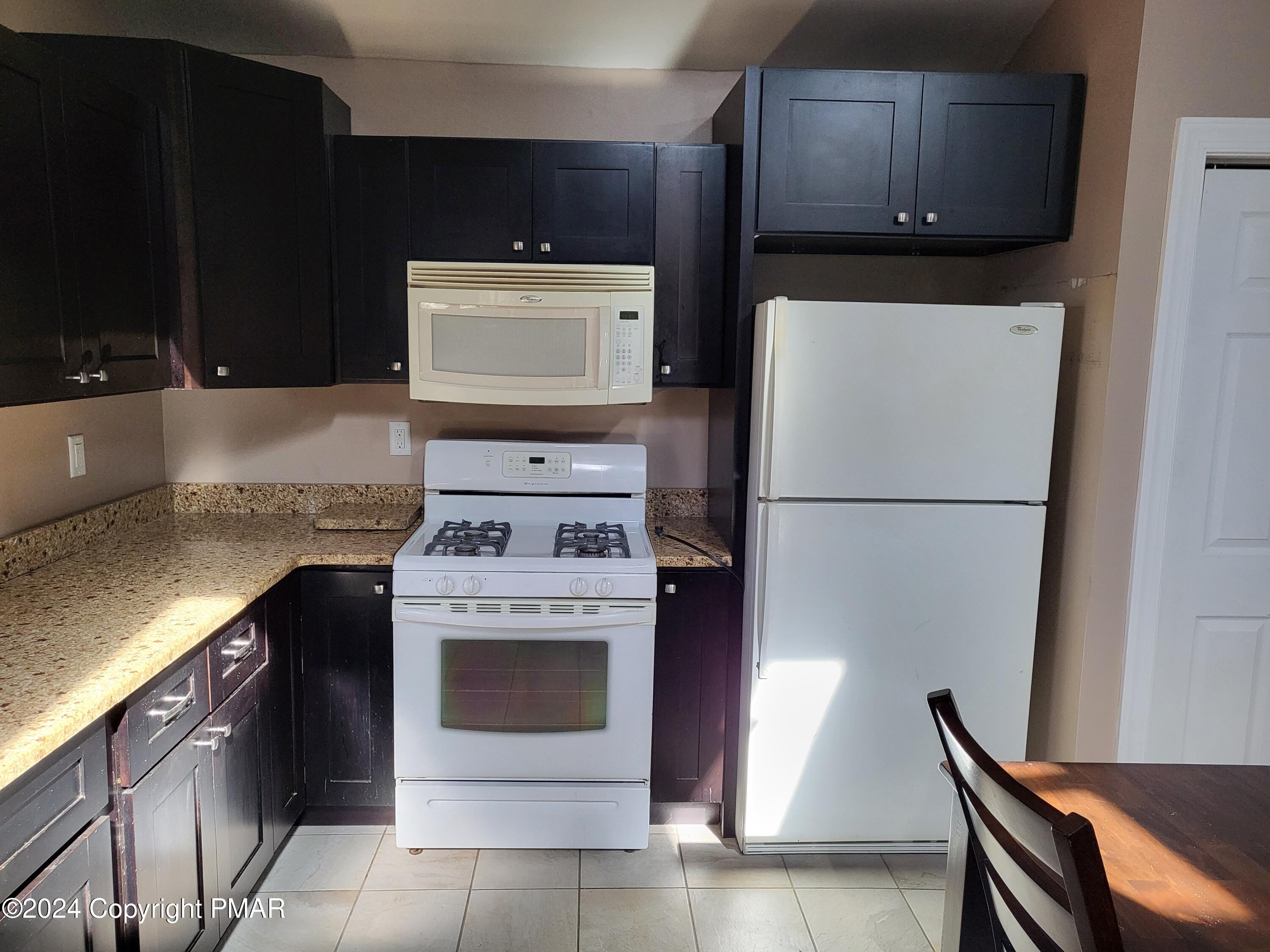 191 Sportsmen Drive Cresco, PA 18326 - Photo 8 of 29 a kitchen with stainless steel appliances granite countertop a stove a refrigerator and a microwave
