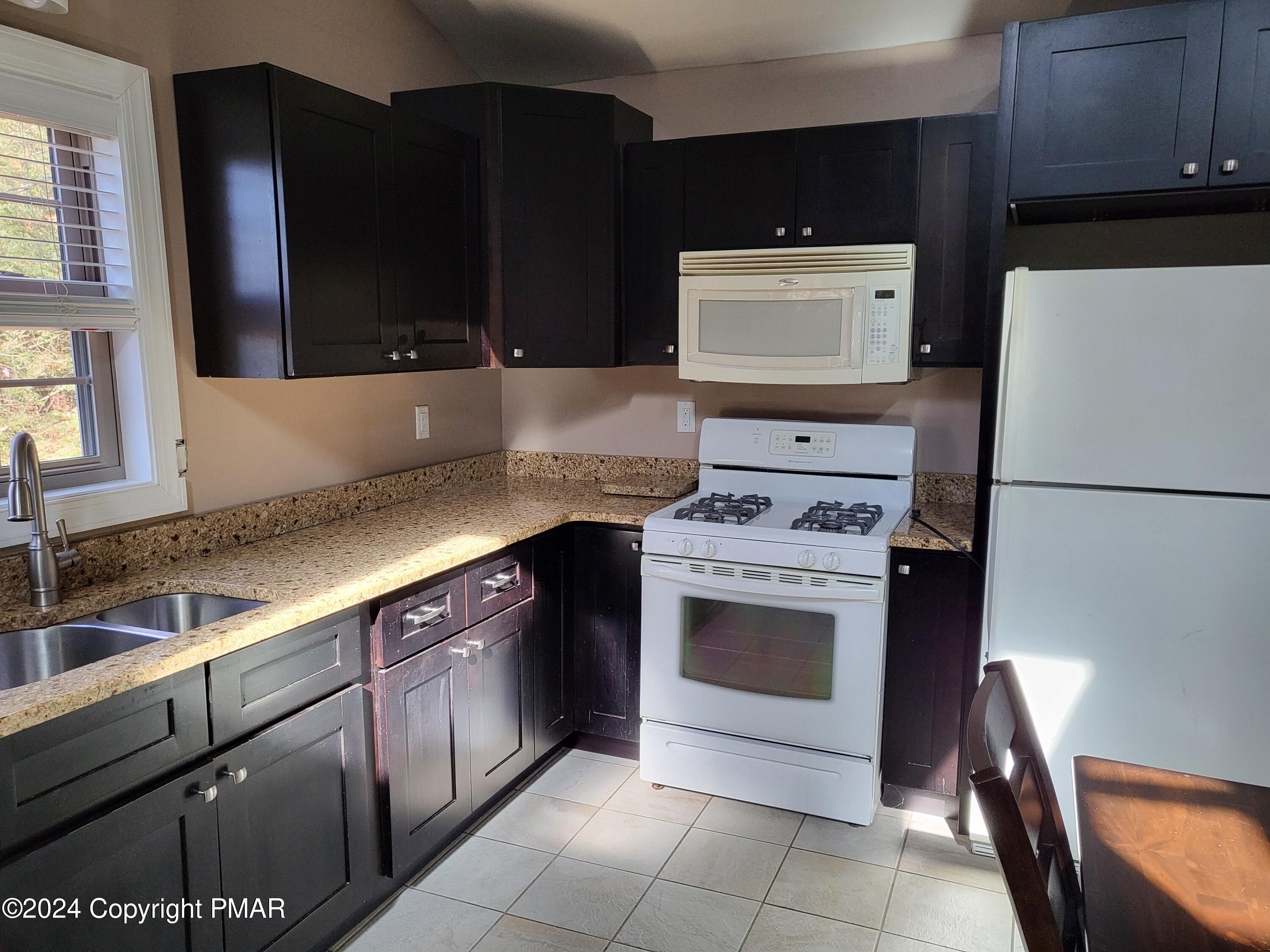191 Sportsmen Drive Cresco, PA 18326 - Photo 10 of 29 a kitchen with a sink and a stove top oven