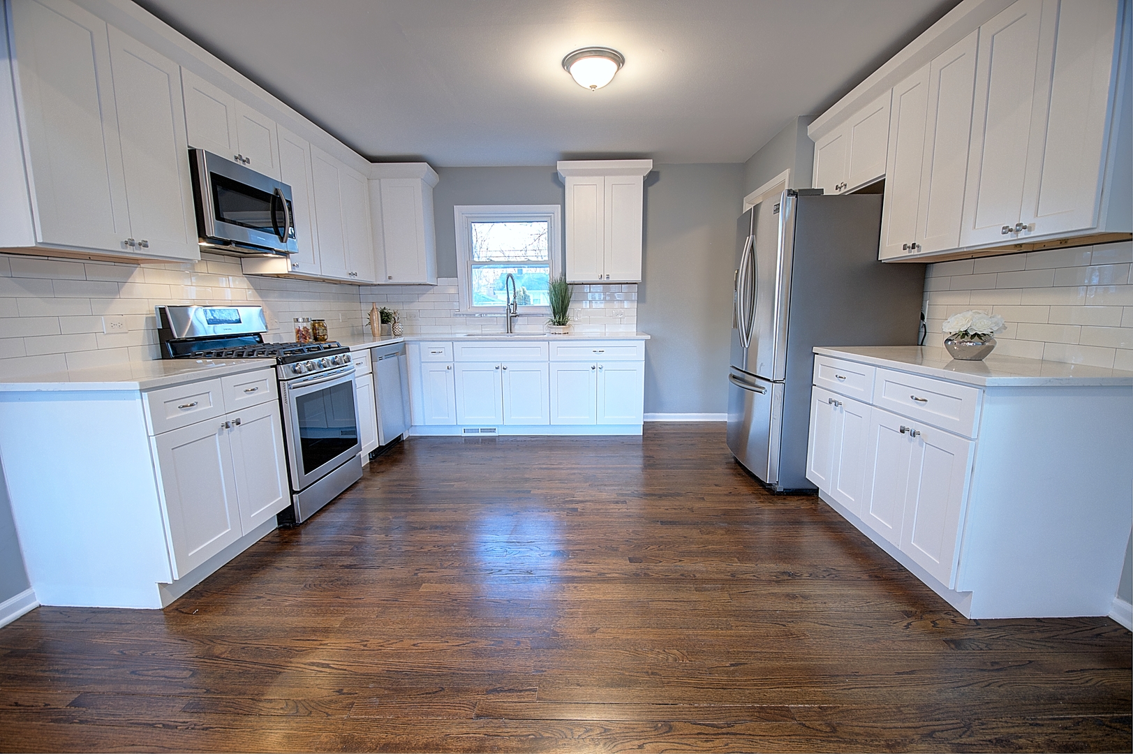 1407 Birch Road Homewood, IL 60430 - Photo 6 of 13 a kitchen with stainless steel appliances granite countertop a stove top oven a sink a refrigerator white cabinets and wooden floor