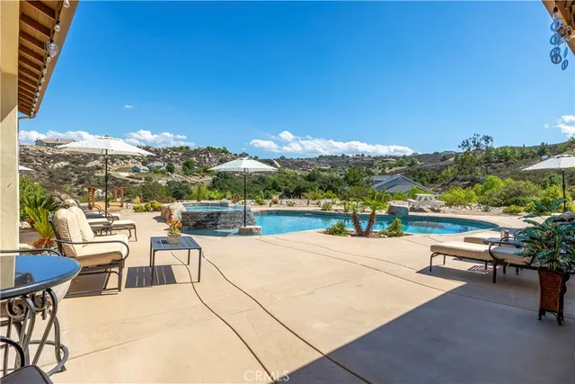 an aerial view of residential houses with outdoor space and ocean view