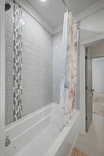 a bathroom with a bathtub and a shower