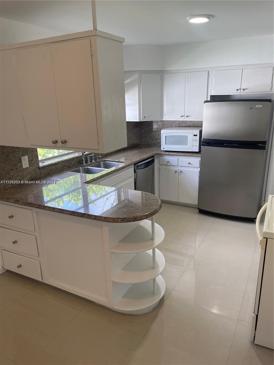Keystone Point North Miami, FL 33181 - Photo 4 of 14 a kitchen with a sink appliances and cabinets