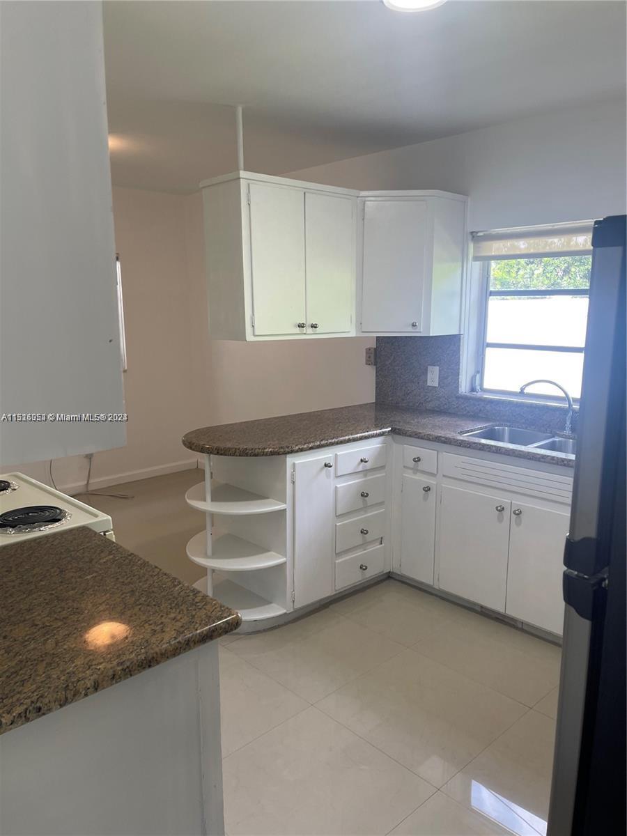 Keystone Point North Miami, FL 33181 - Photo 5 of 14 a kitchen with a sink and cabinets