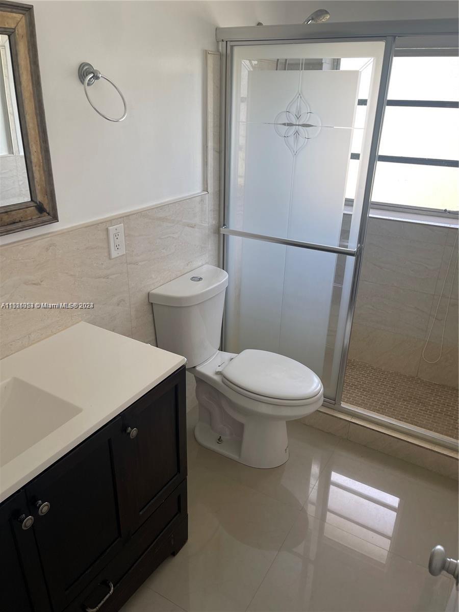 Keystone Point North Miami, FL 33181 - Photo 7 of 14 a white toilet sitting next to a bathroom sink