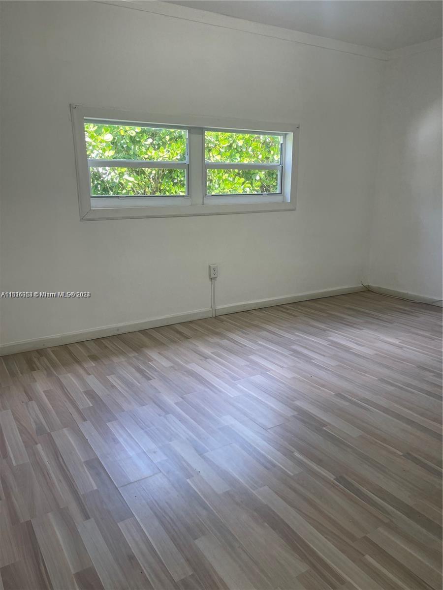 Keystone Point North Miami, FL 33181 - Photo 10 of 14 an empty room with wooden floor and windows