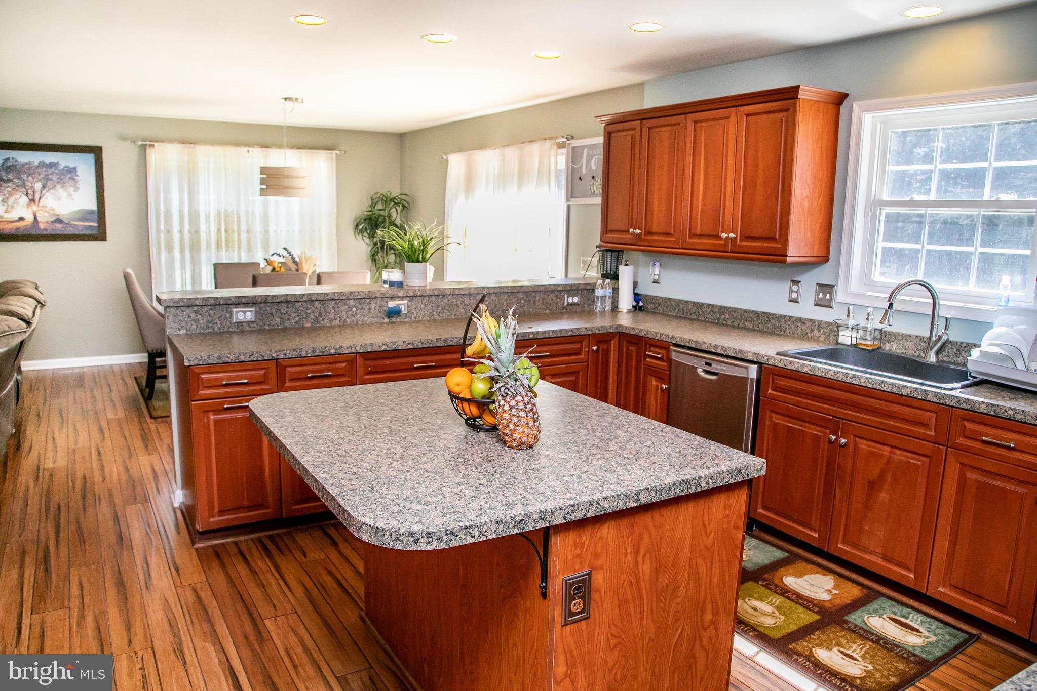 4299 Allen Road Eden, MD 21822 - Photo 5 of 54 a kitchen with stainless steel appliances granite countertop wooden cabinets a sink a stove a dining table and chairs