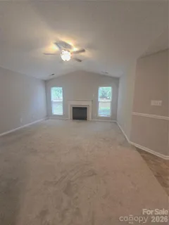 a view of empty room with window and fireplace