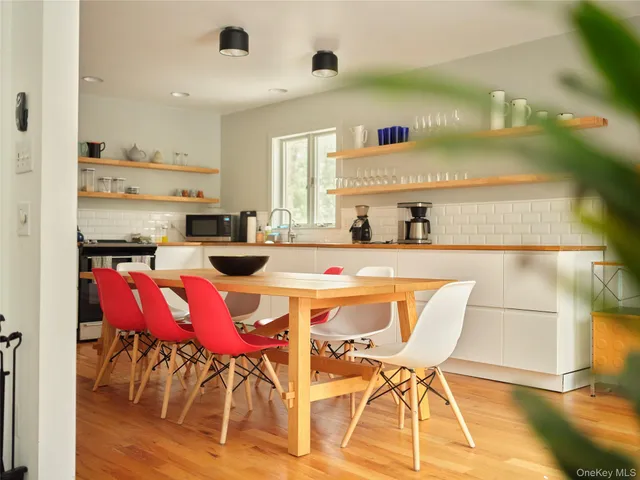 a dining room with furniture and wooden floor