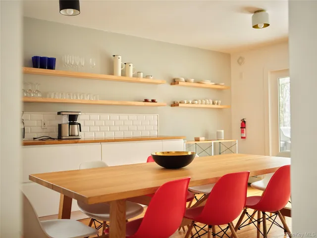 a view of a dining room with furniture and chandelier
