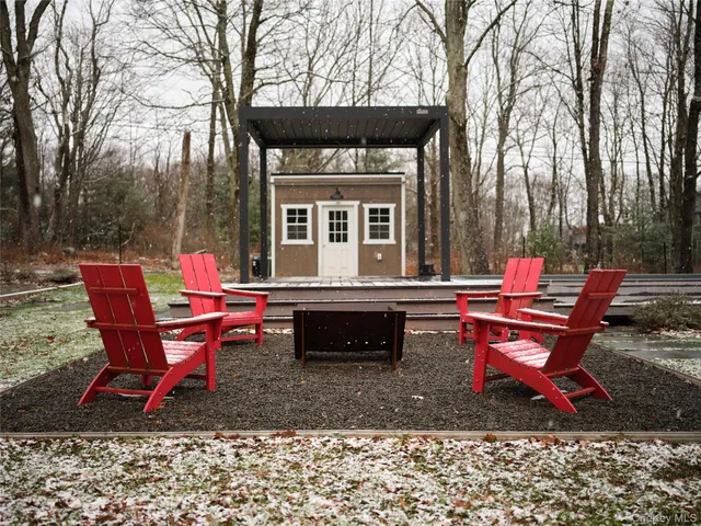 a backyard of a house with table and chairs