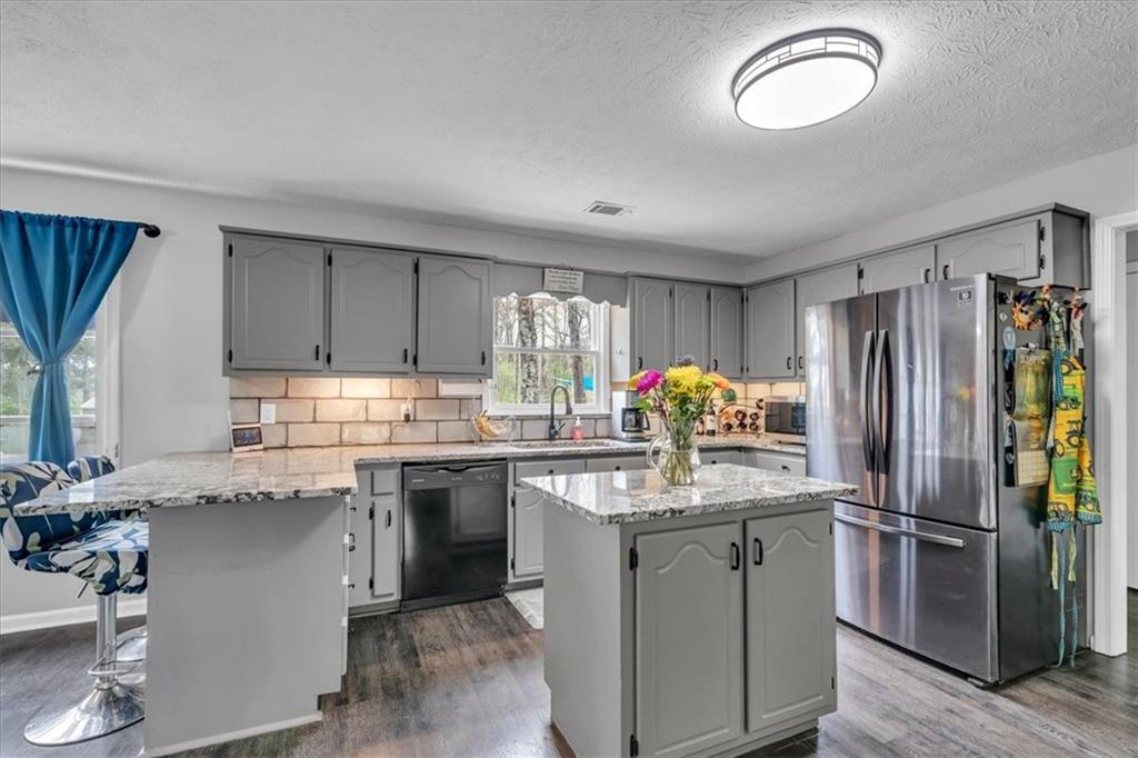 3410 Pilot Road Covington, GA 30014 - Photo 13 of 66 a kitchen with granite countertop a sink appliances and cabinets