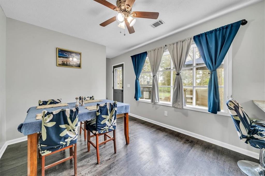 3410 Pilot Road Covington, GA 30014 - Photo 18 of 66 a dining room with furniture a chandelier and wooden floor