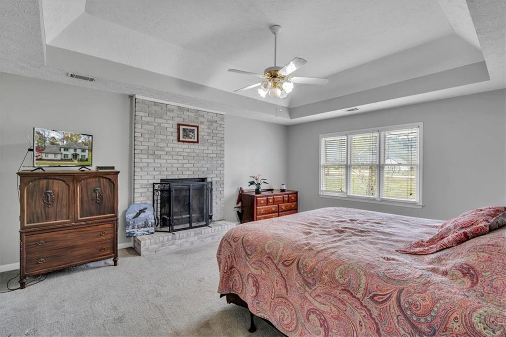 3410 Pilot Road Covington, GA 30014 - Photo 20 of 66 a spacious bedroom with a bed and a fireplace