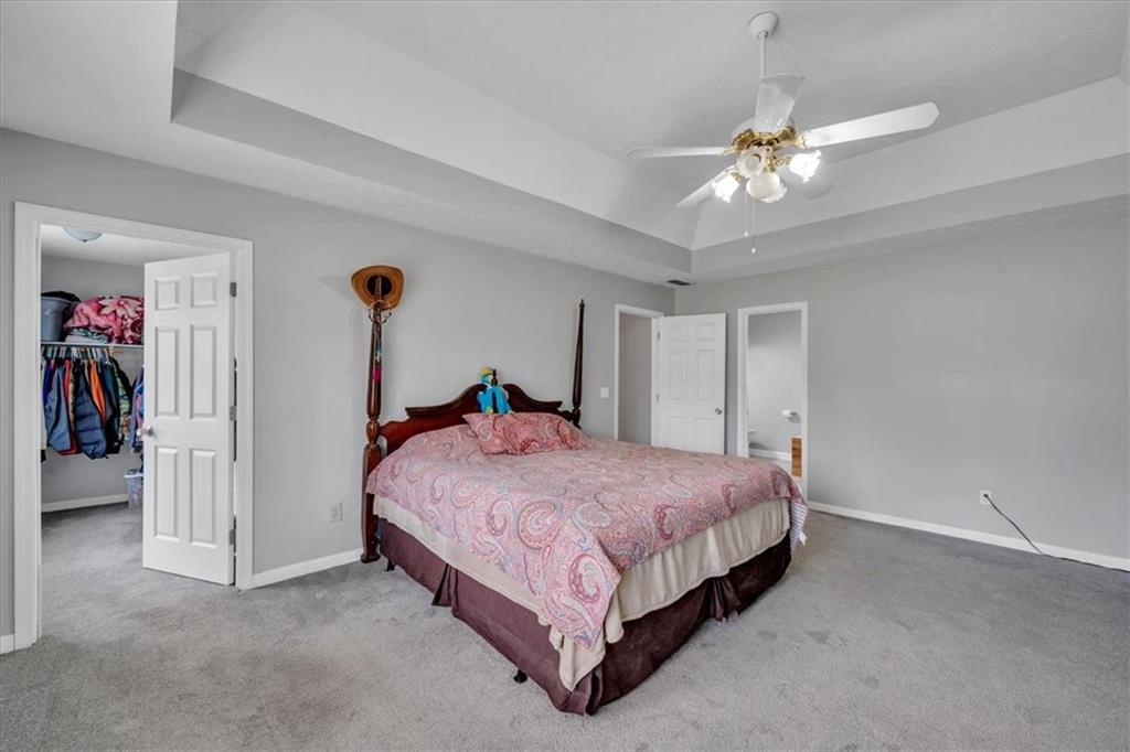 3410 Pilot Road Covington, GA 30014 - Photo 22 of 66 a spacious bedroom with a bed and a chandelier