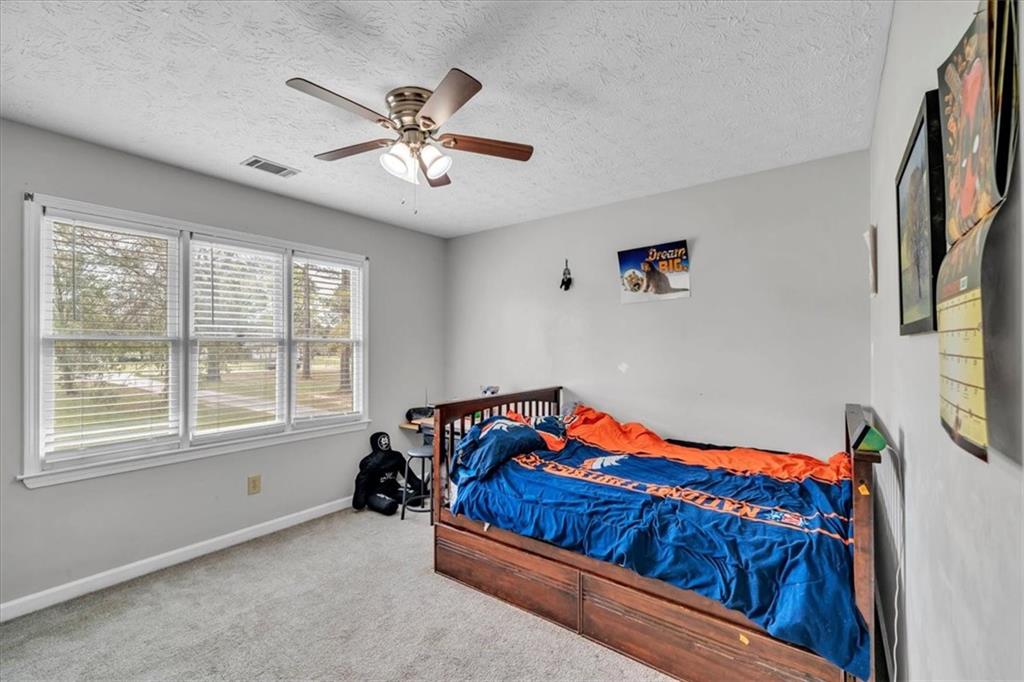 3410 Pilot Road Covington, GA 30014 - Photo 29 of 66 a bedroom with a bed and a chandelier