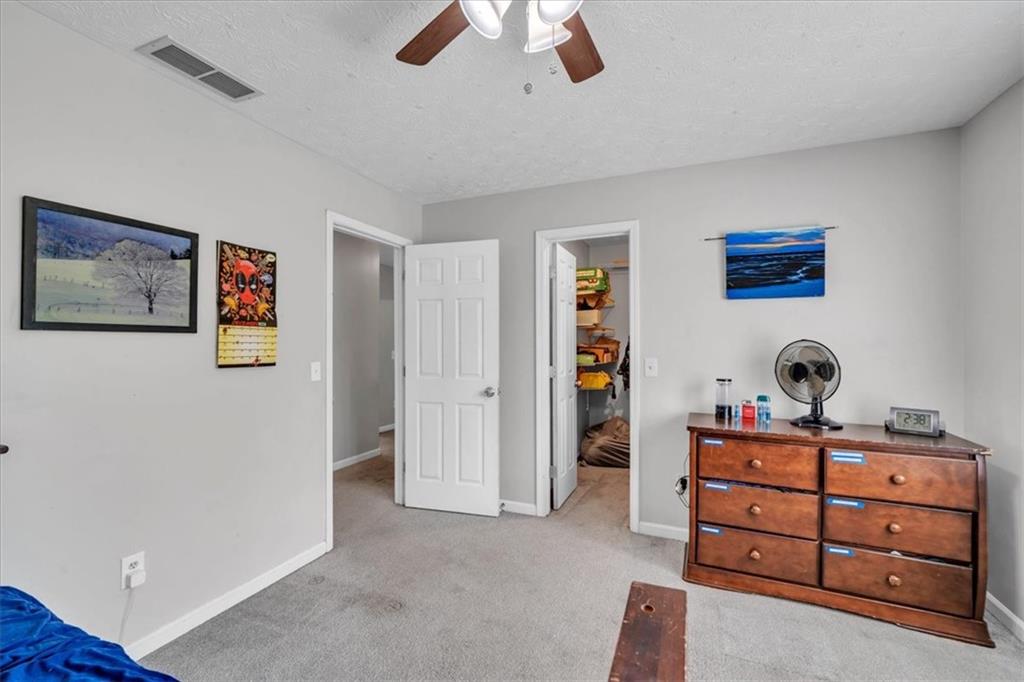 3410 Pilot Road Covington, GA 30014 - Photo 30 of 66 a room with a bed and a ceiling fan