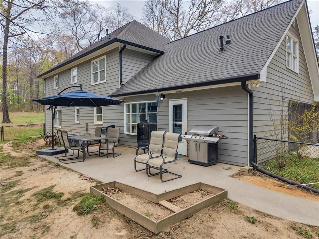 3410 Pilot Road Covington, GA 30014 - Photo 34 of 66 a view of a patio with table and chairs under an umbrella