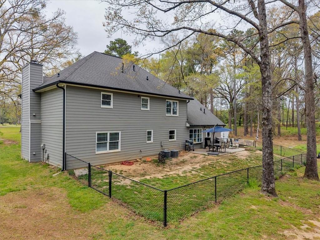 3410 Pilot Road Covington, GA 30014 - Photo 36 of 66 a view of a house with a wooden bench in a yard