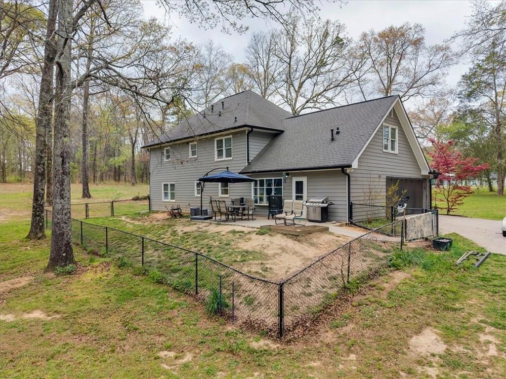 3410 Pilot Road Covington, GA 30014 - Photo 43 of 66 a front view of house with yard slide and trees