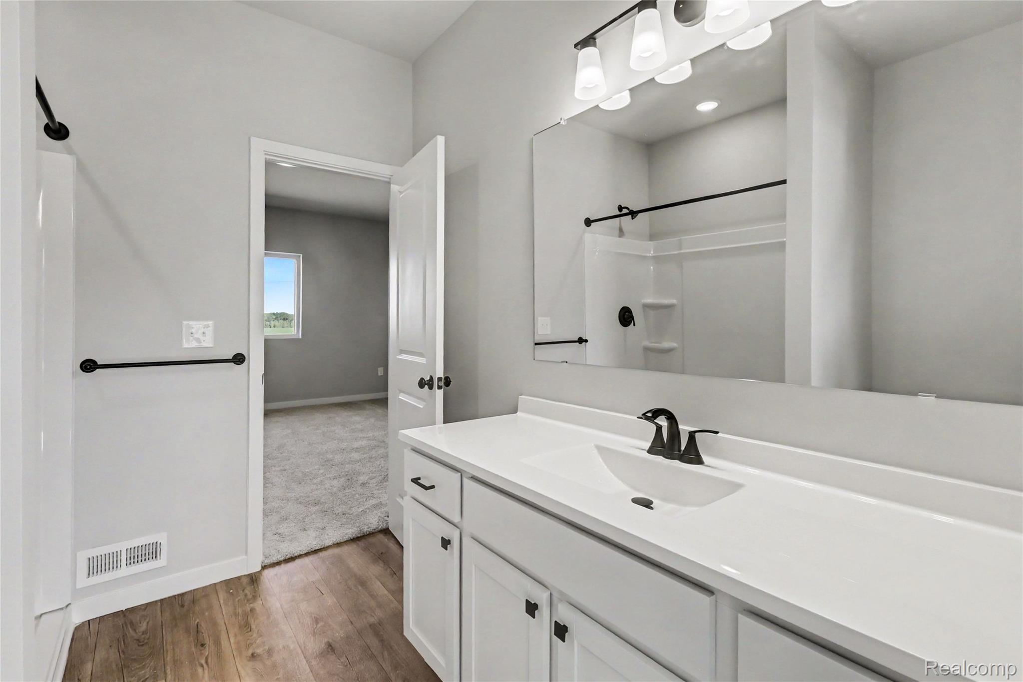 5528 Lahring Road Linden, MI 48451 - Photo 8 of 39 The primary suite is located on the upper level and includes a private bath and oversized walk-in closet with large window for natural lighting.