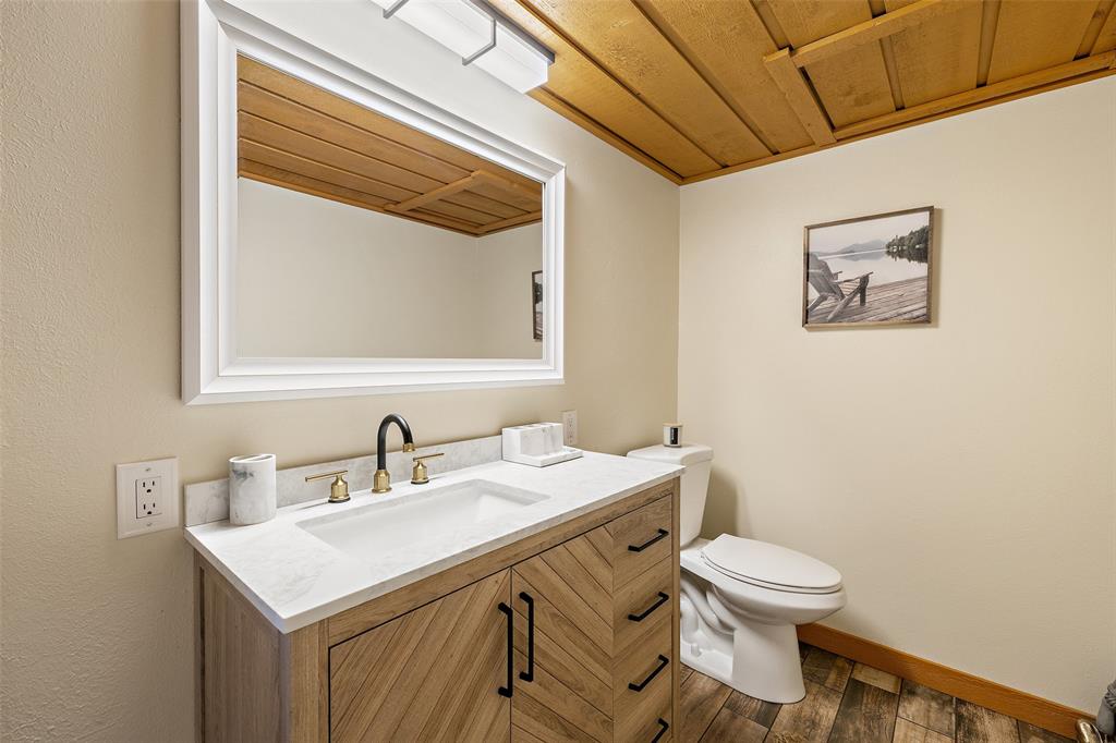 318 Coventry Road Spicewood, TX 78669 - Photo 11 of 38 Bathroom with vanity and dark wood-style flooring