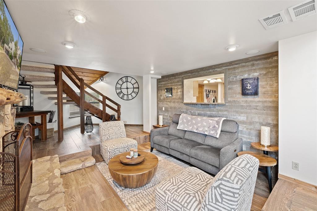 318 Coventry Road Spicewood, TX 78669 - Photo 20 of 38 Living area with wood finished floors and an accent wall