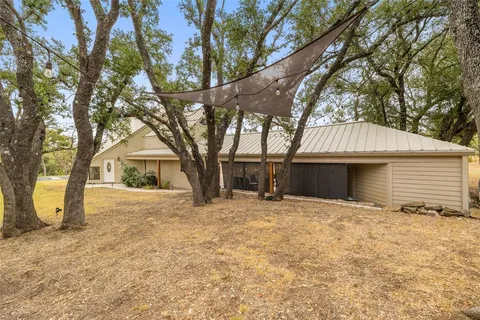 a front view of house with yard and trees
