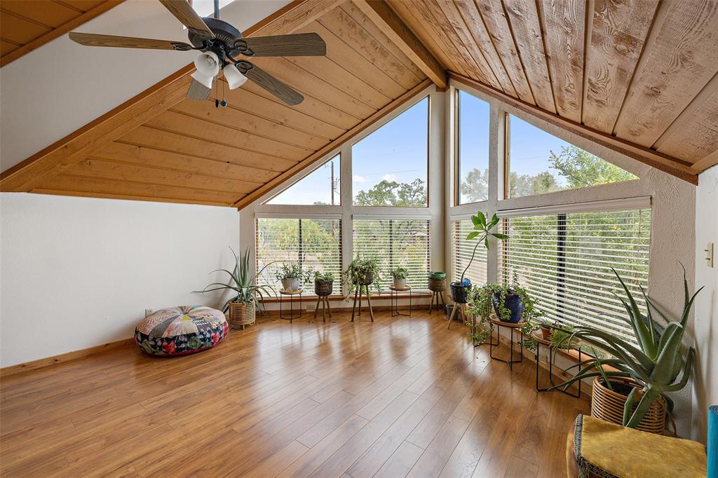 318 Coventry Road Spicewood, TX 78669 - Photo 4 of 38 Sunroom with a wood ceiling with exposed beams and hardwood / wood-style floors