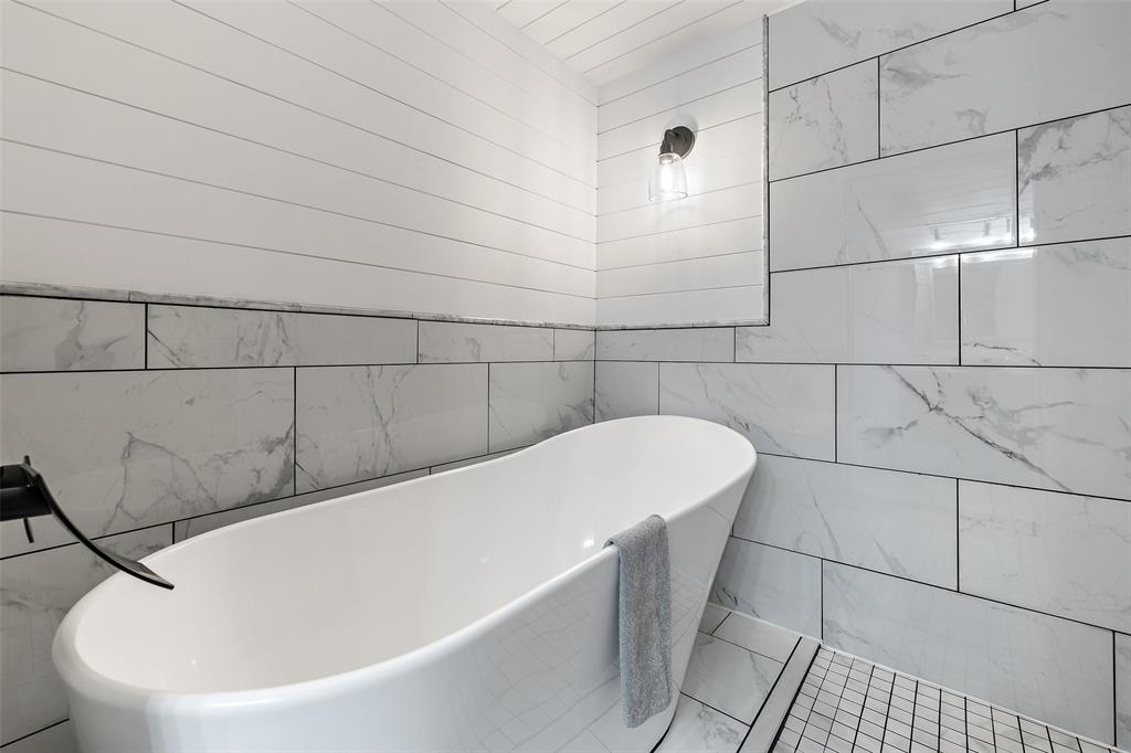 318 Coventry Road Spicewood, TX 78669 - Photo 7 of 38 Full bath featuring tile walls and a freestanding bath