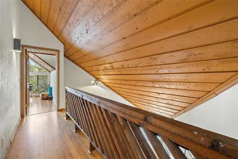 a view of a balcony with wooden floor